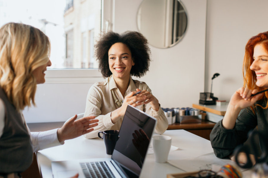 three females co-worker talking to each other